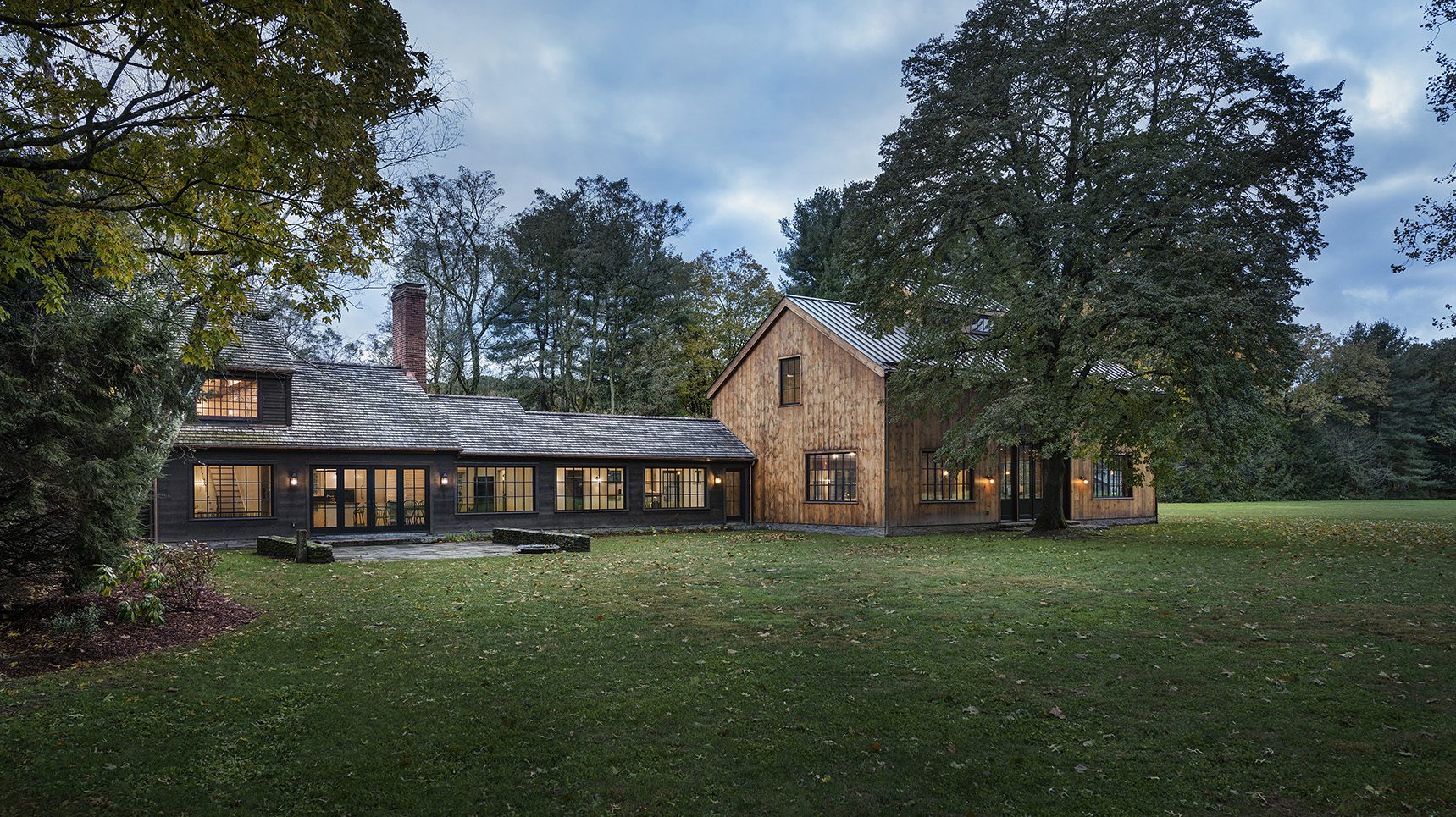 Renovated historic farmhouse at dusk 