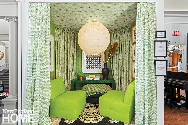 Vibrant green sitting area featuring patterned drapery, lime green chairs, a tufted ceiling, a central paper lantern, and eclectic decor with artistic accents.