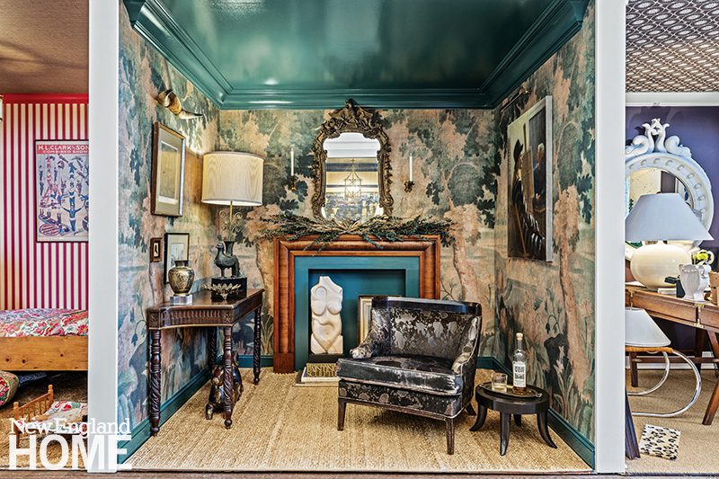 Eclectic room vignette by Courtney Blanton featuring vintage-inspired wallpaper, a high-gloss green ceiling, ornate mirror, antique furniture, and artistic decor.