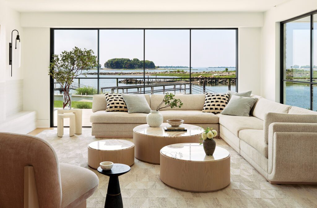 Light-filled living room with a sectional sofa and sweeping water views.