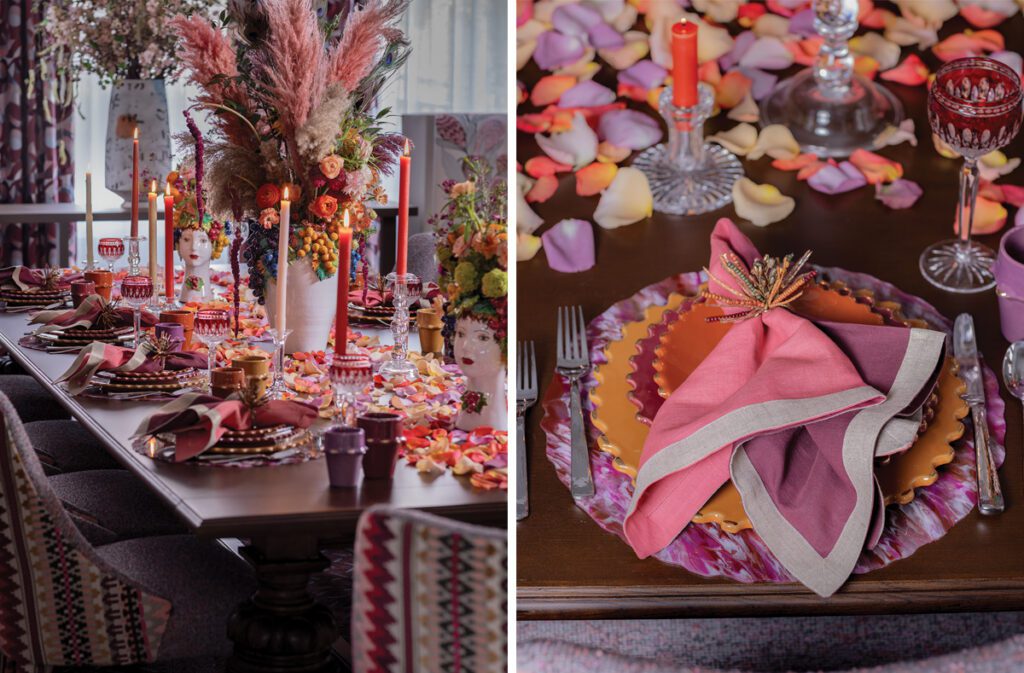 An opulently set table with pampas grasses, rose petals, and bold color.