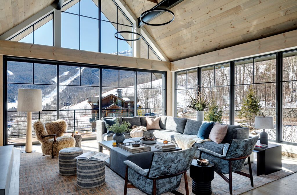 Expansive great room with floor-to-ceiling windows and mountain views